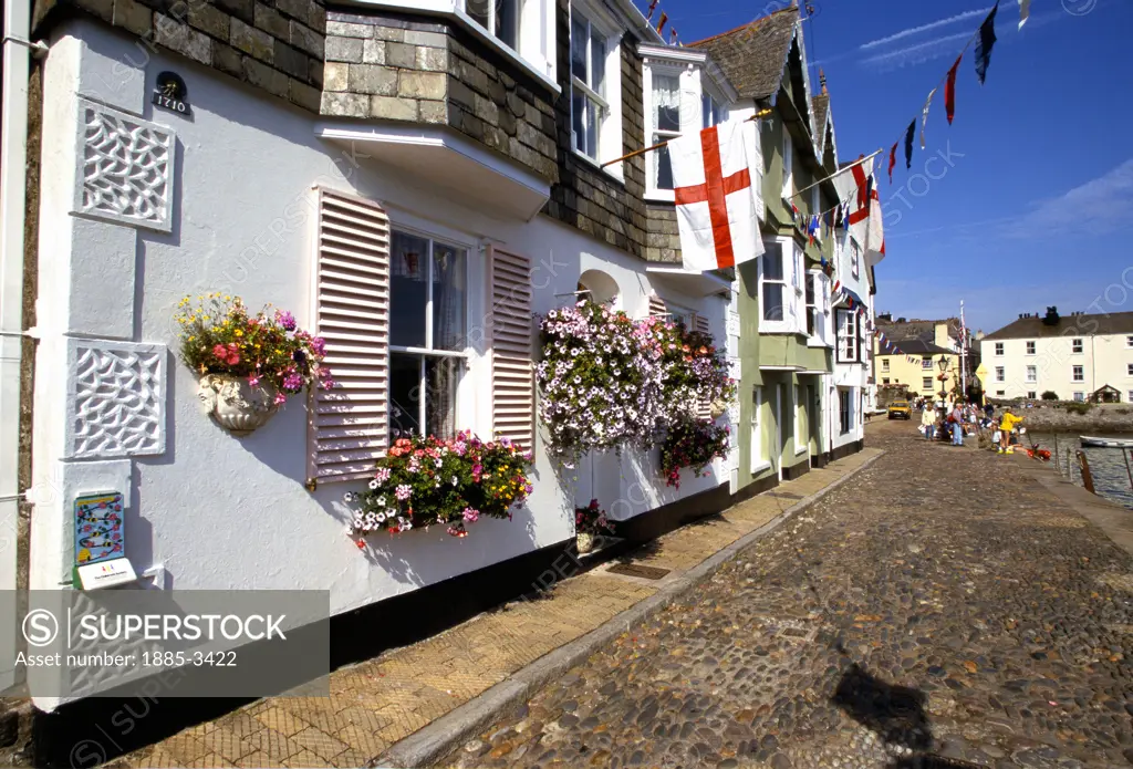 UK - England, Devon, Dartmouth, Street Scene with flags and flowers on harbourside buildings