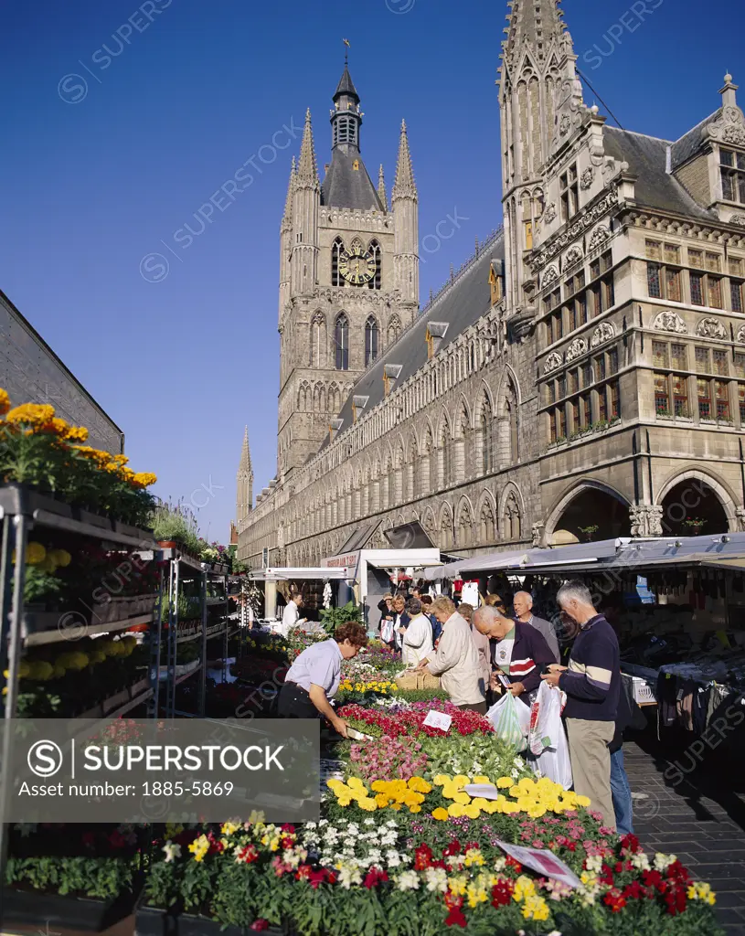 Belgium, Flanders, Ypres (Ieper), Flower Market with the Cloth Hall Behind