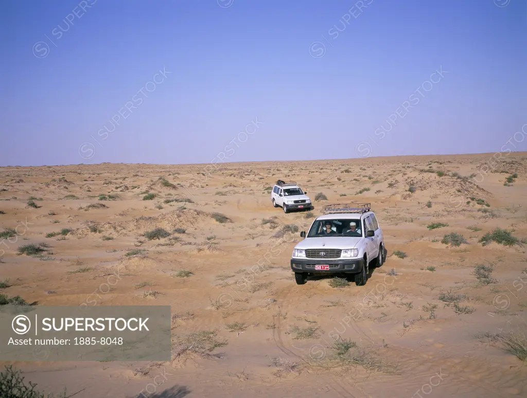 Oman, , Wahiba Sands, Landcruisers in Desert Landscape
