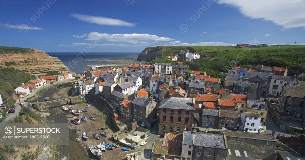 UK - England, Yorkshire, Staithes, View over fishing village and harbour at low tide