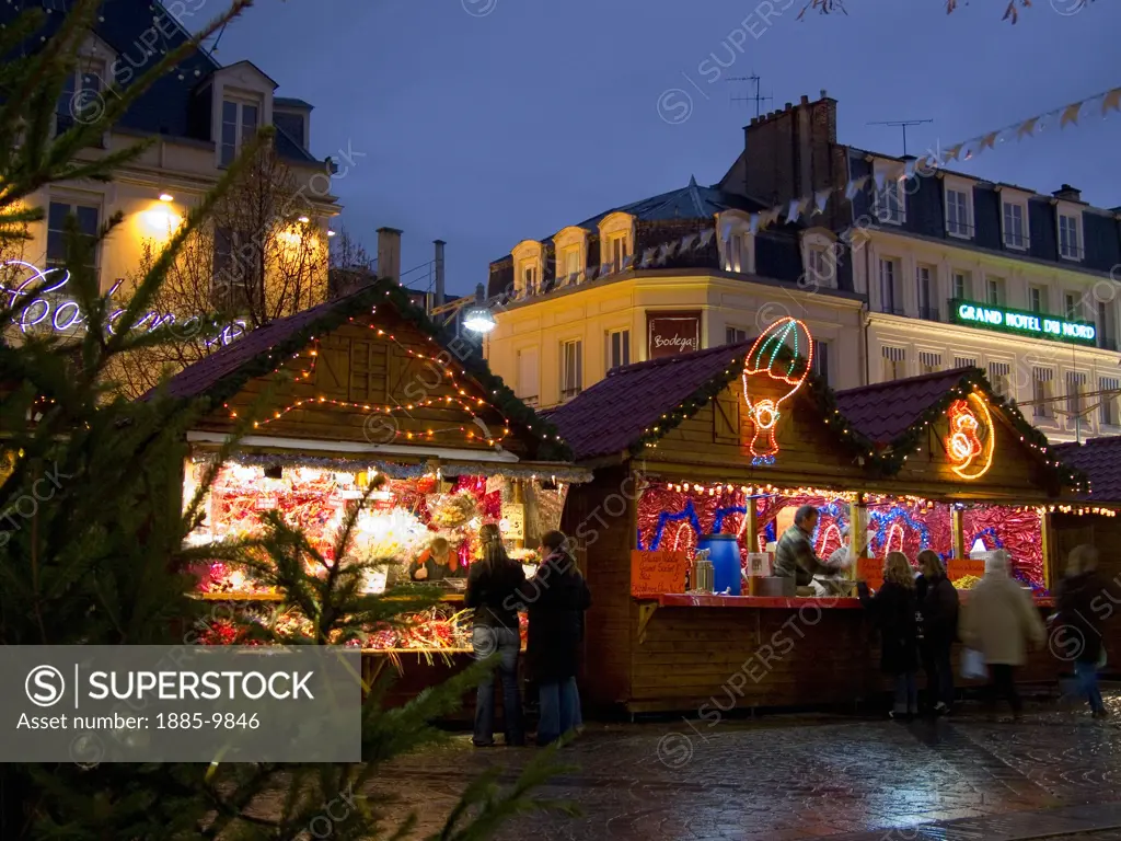 France, Champagne & The Ardennes, Reims, Christmas Market stalls on Place d'Erlon with Grand Hotel du Nord in background
