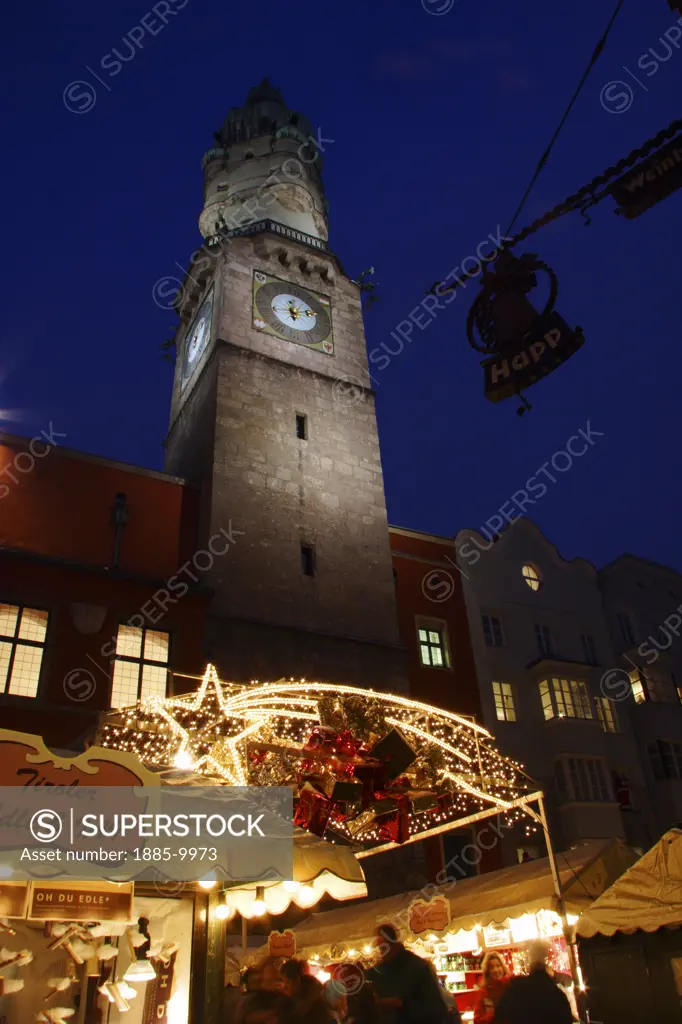 Austria, Tyrol, Innsbruck, Clocktower and Christmas market stalls in the Old Town