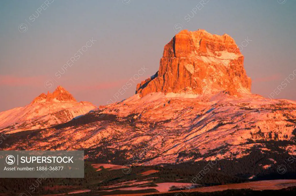 Early snow frosts Chief Mountain, an eroded mountain at sunrise, Glacier National Park, Montana, USA.