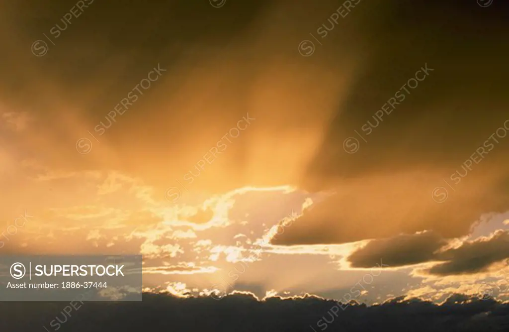 Sunset/sunrise, storm clouds and ""god"" or light rays.