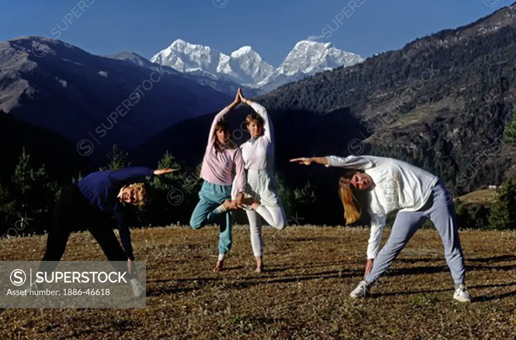 Trekkers practice yoga with a Himalayan backdrop - SOLU TREK, NEPAL