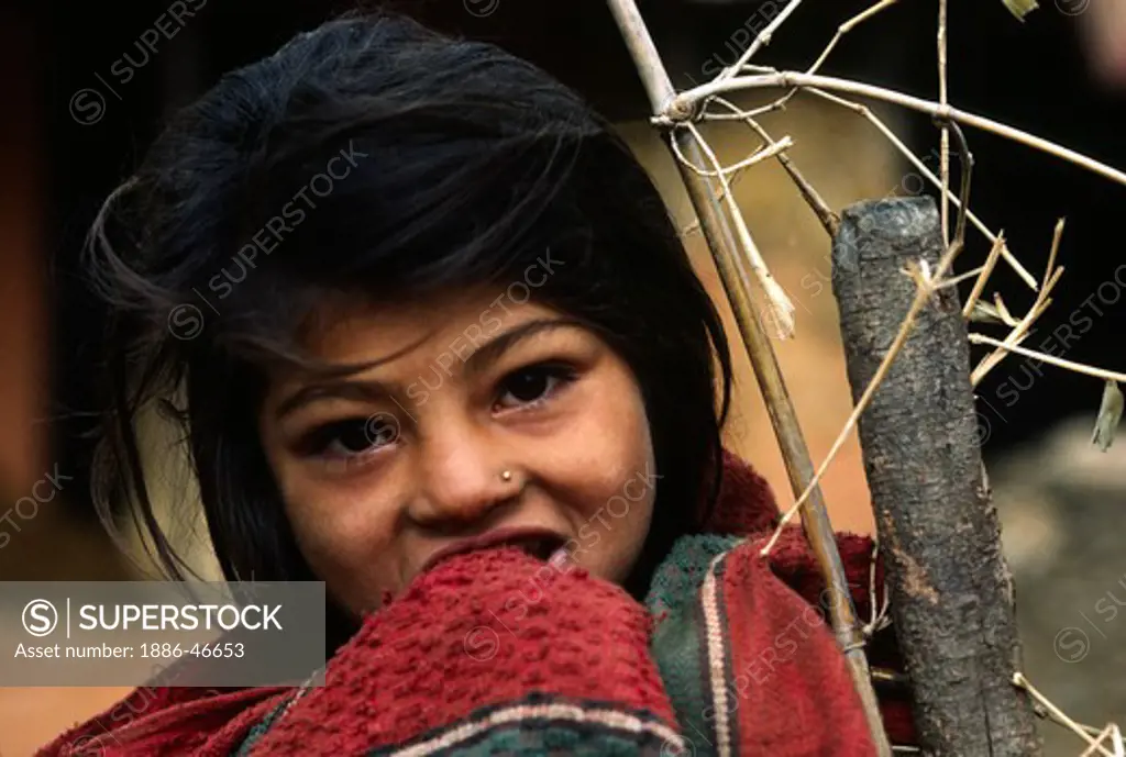 PORTRAIT of a beautiful young TAMANG GIRL with a head shawl - ANNAPURNA REGION, CENTRAL NEPAL