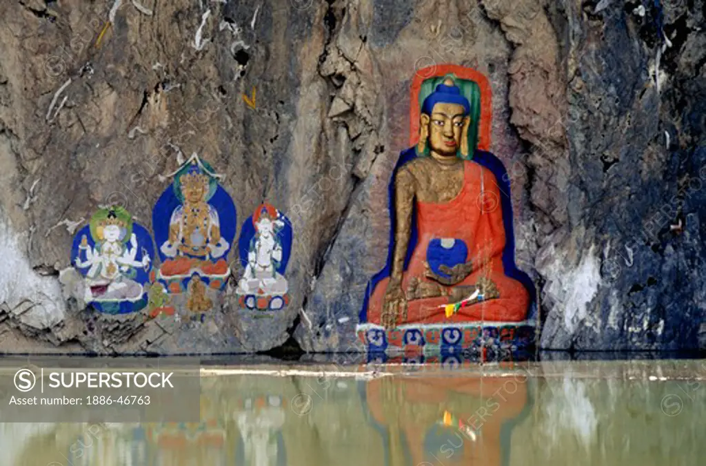An 11th century SHAKYAMUNI BUDDHA is carved out of a stone cliff near LHASA with paintings of TARA TIBET