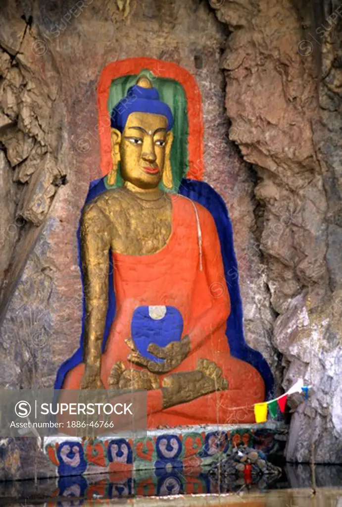 An 11th century SHAKYAMUNI BUDDHA is carved out of a stone cliff near LHASA , TIBET