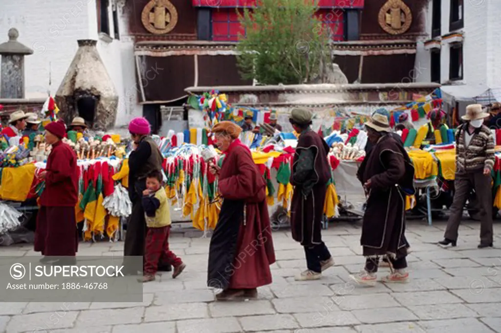 TIBETANS circumnambulate the Jokhang Temple along the BARKOR  a TIBETAN Bazaar - LHASA, TIBET