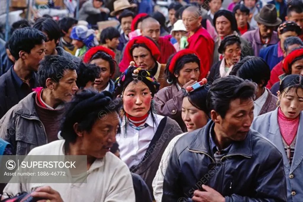 THE BARKHOR a TIBETAN Bazaar is flooded with TIBETANS making their evening KORA around the Jokhang Temple - LHASA, TIBET