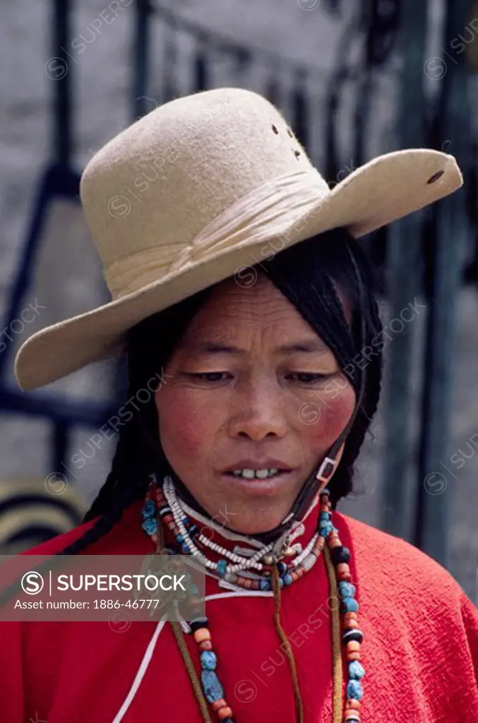 Traditionally dressed TIBETAN WOMAN on the BARKHOR or TIBETAN Bazaar - LHASA, TIBET