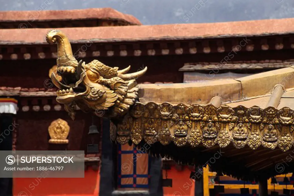 A GOLDEN DRAGON is one of the many elaborate ROOF DETAILS found on the JOKHANG - LHASA, TIBET