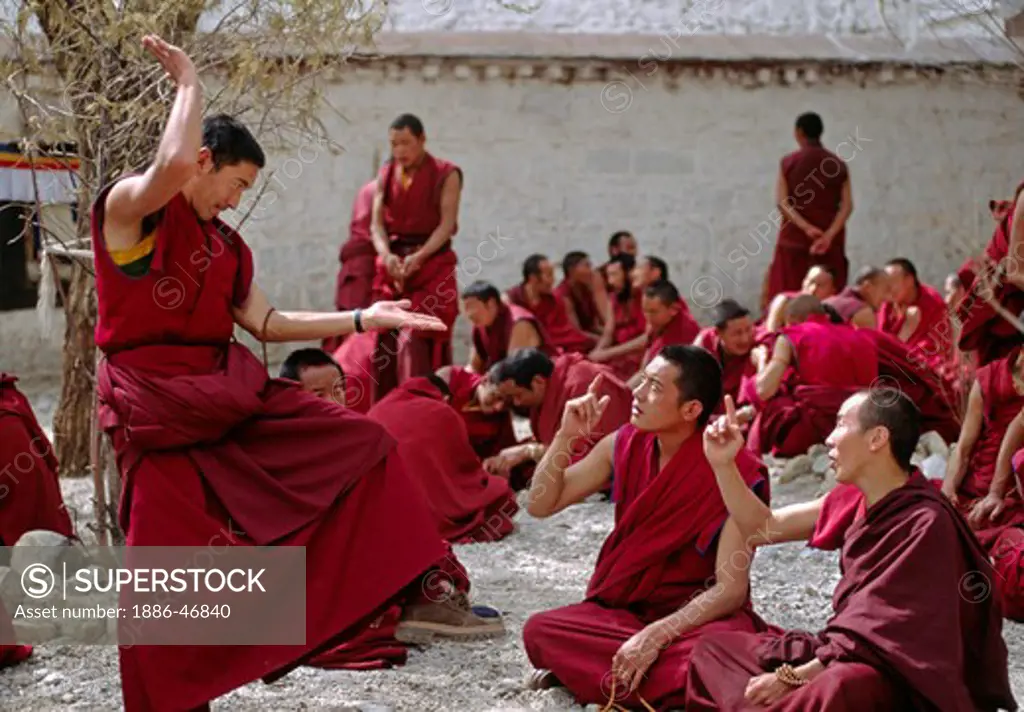 MONKS DEBATE the finer points of TIBETAN BUDDHISM in this historical form of learning at SERA MONASTERY - LHASA, TIBET