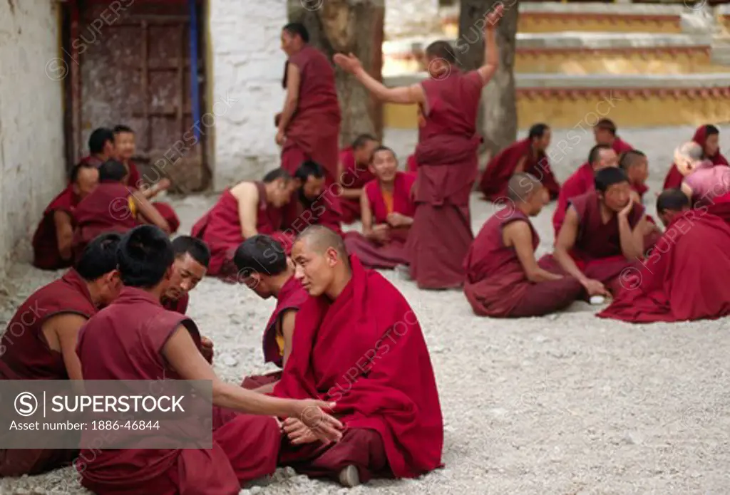 MONKS DEBATE the finer points of TIBETAN BUDDHISM in this historical form of learning at SERA MONASTERY - LHASA, TIBET