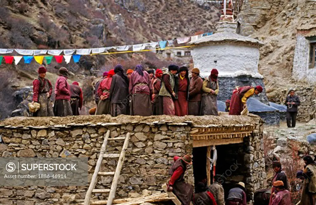 NUNS gather to repair a roof at TERDROM NUNNERY started by YESHE TSOGYEL who was PADMASAMBHAVA'S CONSORT -  CENTRAL, TIBET
