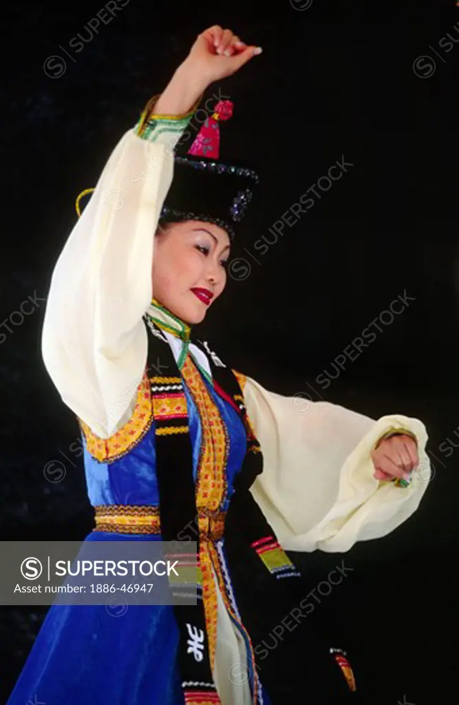 A female MONGOLIAN DANCER performs a traditional DANCE from MONGOLIA in NATIVE COSTUME