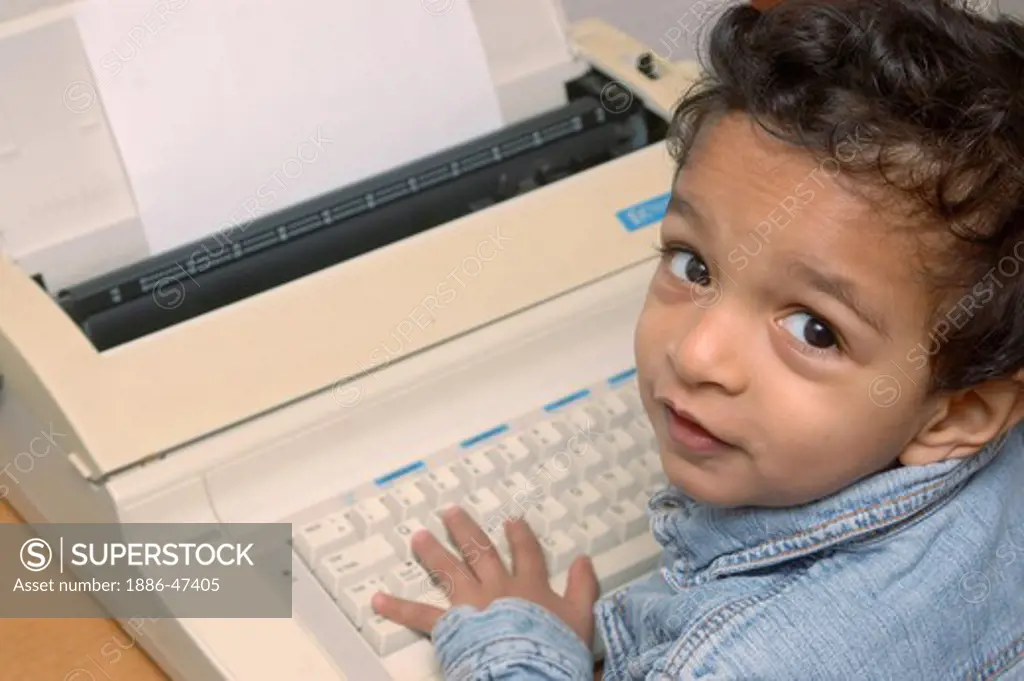 Small boy on electronic typewriter, MR # 468