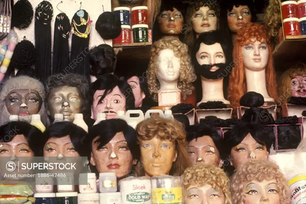 Wigs; false beards; moustaches and hair displayed on face masks along with cosmetic products at a beauty shop ; Bombay Mumbai ; Maharashtra ; India