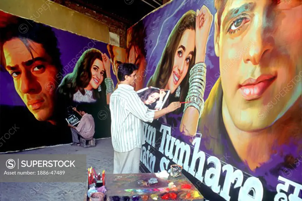 Artist painting bollywood film hoardings ; Mumbai Bombay ; Maharashtra ; India
