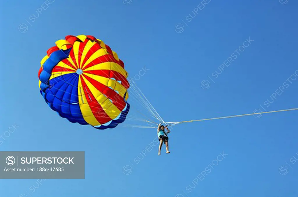 Tricolor Parasail against blue sky Parasailing water sports Parasailing Pattaya ; Thailand ; South East Asia