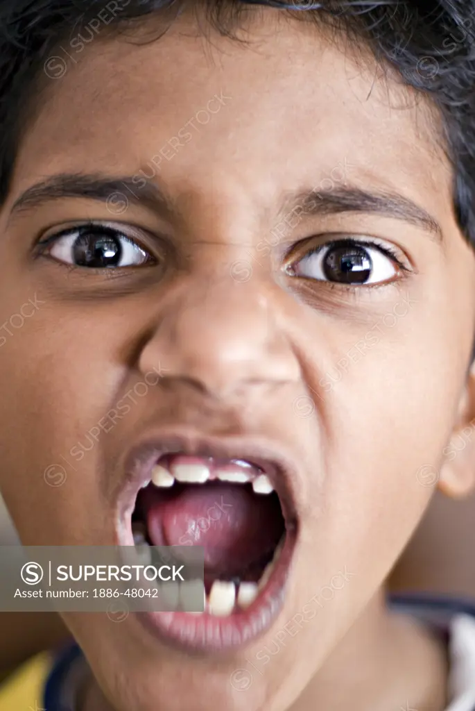 South Asian Indian eight year old boy Dhruv Karve roaring making face like tiger ; Bombay Mumbai ; Maharashtra ; India MR#688