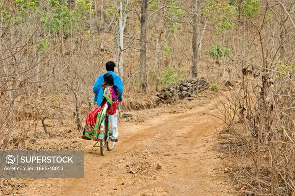 Tribal couple riding bicycle on their way of home cheapest mode of transport for poor ; Thane district near Mumbai Bombay ; Maharashtra ; India
