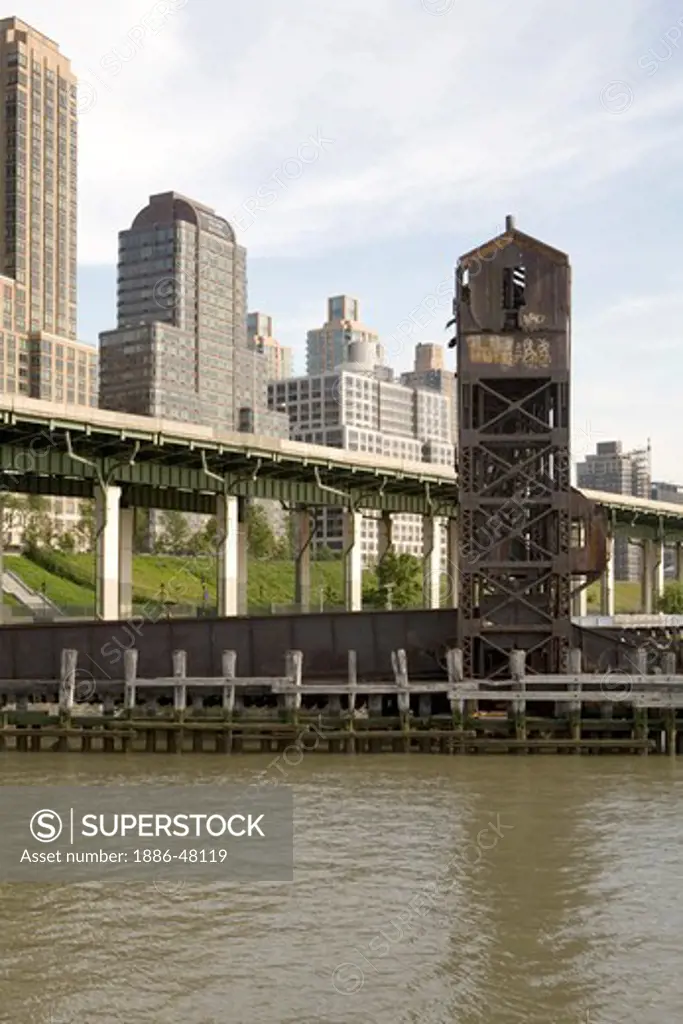 An old structure on the Hudson river with modern buildings of Manhattan in the background ; New York ;  U.S.A. United States of America