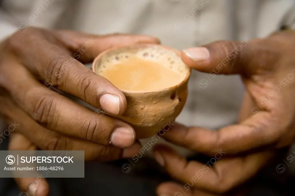 Drinks ; Man holding tea in clay pot Kulhad ; Park street ; Calcutta now Kolkata ; West Bengal ; India