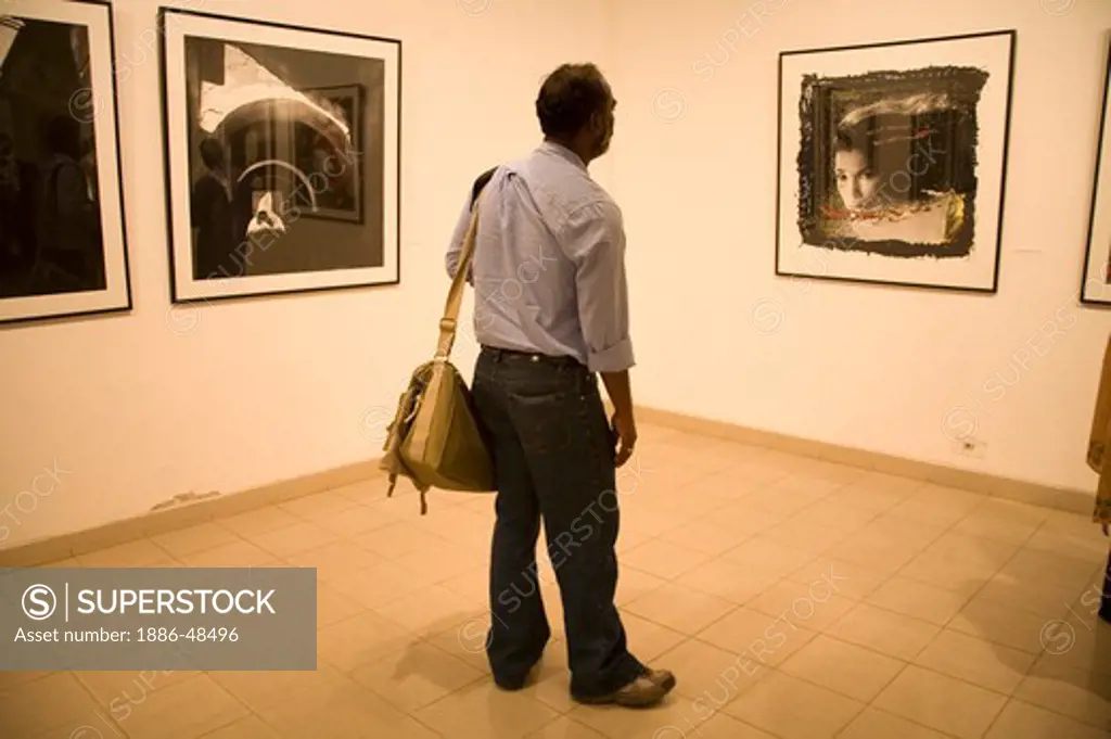Exhibition of fine art photography photographers looking at pictures Chobi Mela ;  Dhaka ; Bangladesh Nov 2006