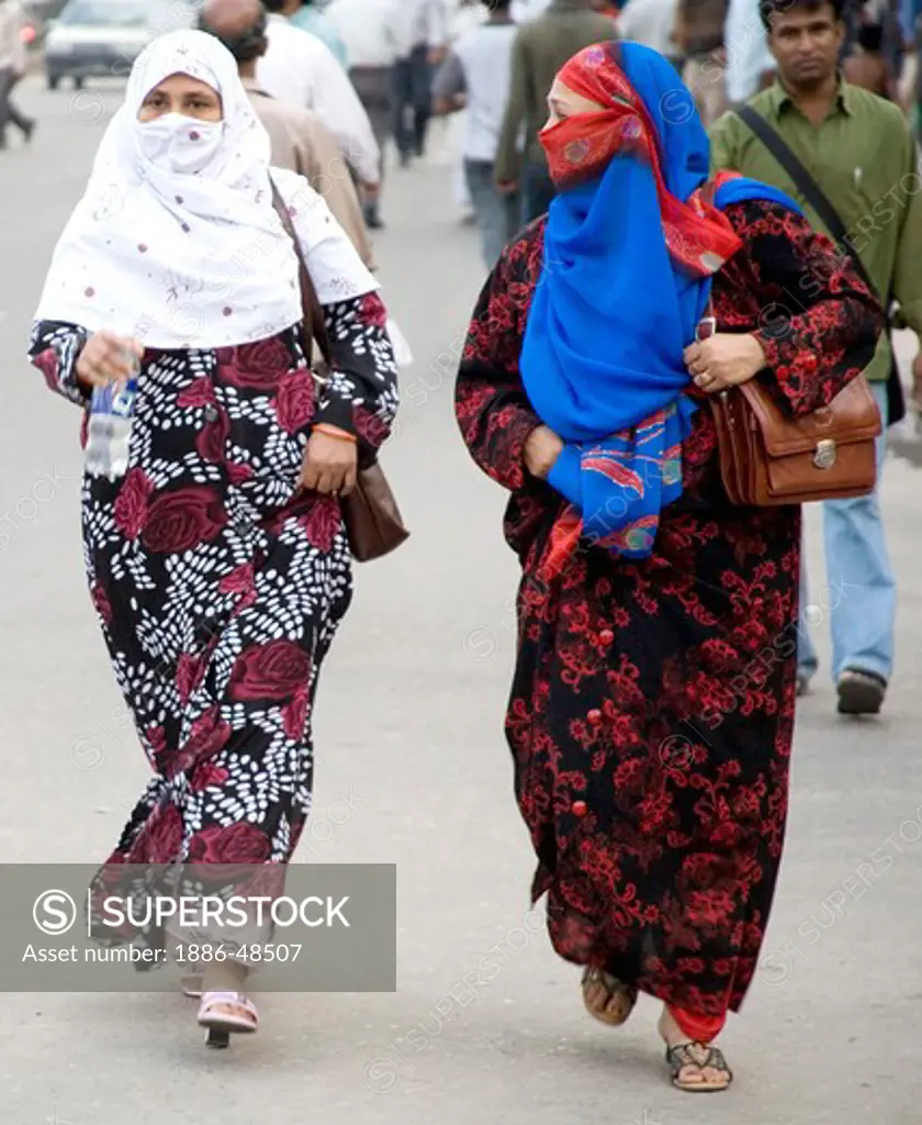 Two middle age Muslim women with face covered walking on street ; Dhaka ;  Bangladesh