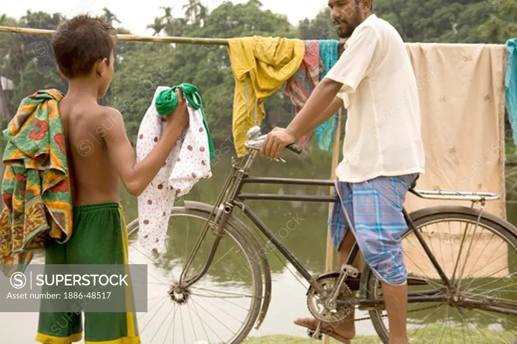 Cyclist and boy ; father and son ; small village Tauta ; district Manik gunj ;  Bangladesh