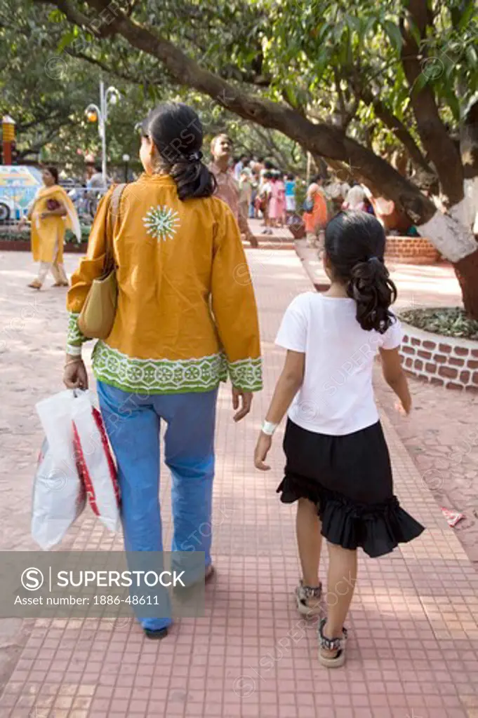 South Asian Indian woman and girl walking in Amusement park Tikuji ni wadi ; Bombay Mumbai ; Maharashtra ; India MR#202