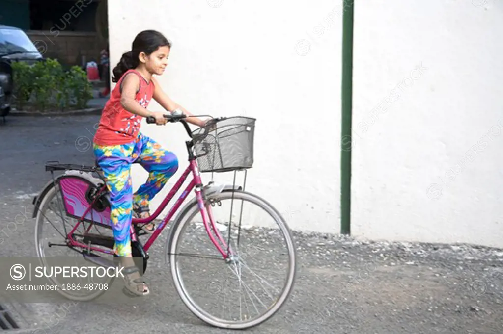 South Asian Indian girl Sanchi riding bicycle ; Bombay Mumbai ;  Maharashtra ; India MR#202