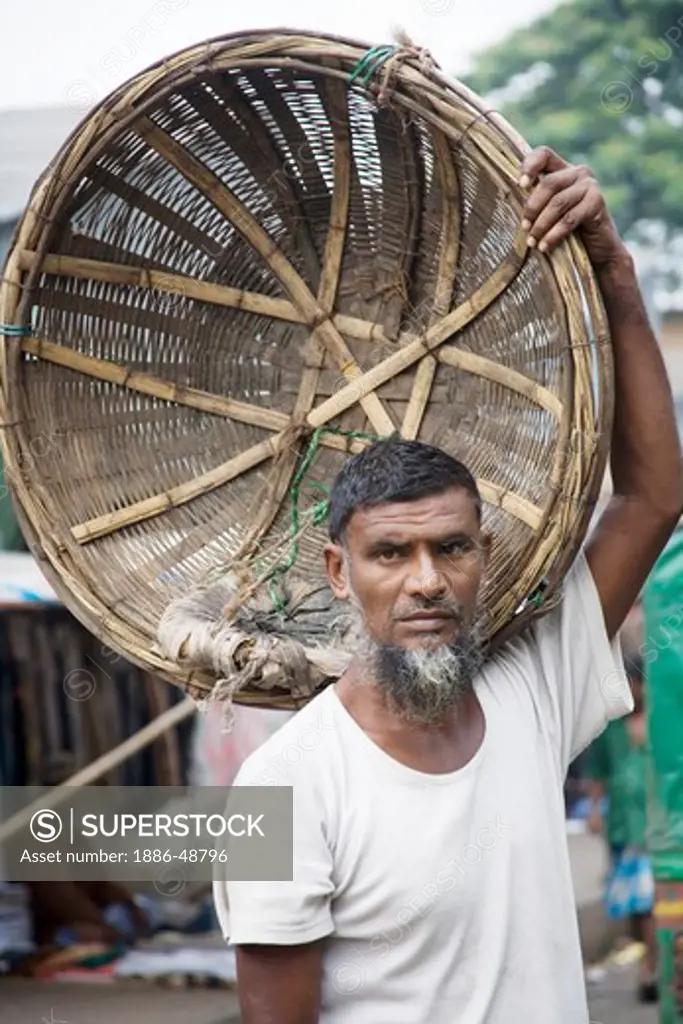 Muslim man with bamboo basket use to carry luggage ; Dhaka ; Bangladesh