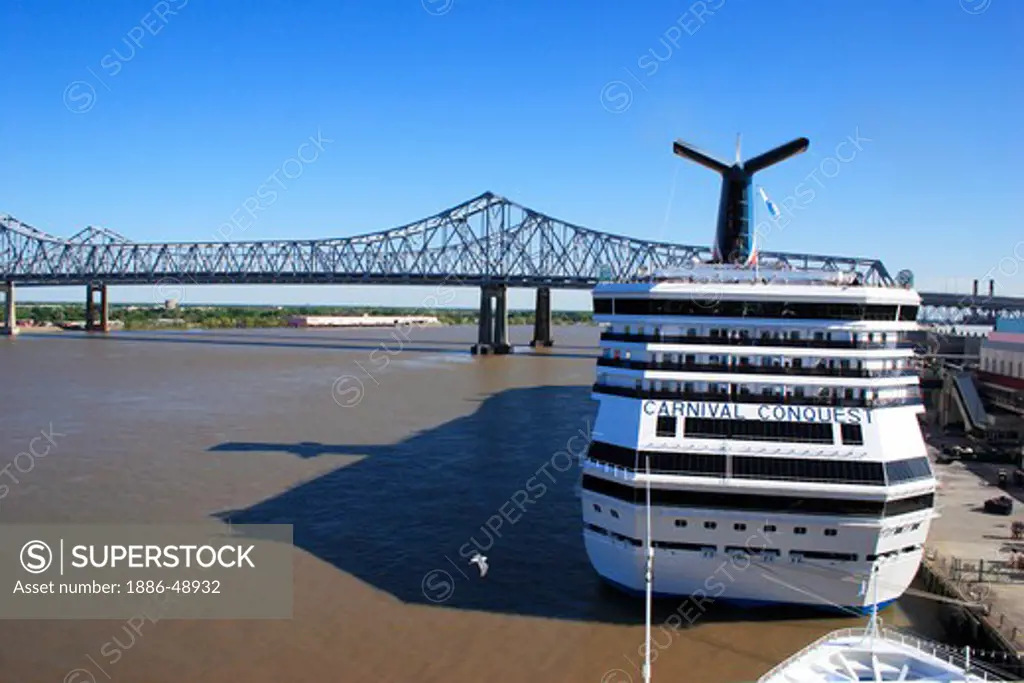 Cruise ship near the crescent city connection bridge over the Mississippi river ; formerly the greater New Orleans bridge ; Twin cantilever bridges ; 5th longest cantilever bridges in the world ; New Orleans ; Louisiana ; U.S.A. United States of America