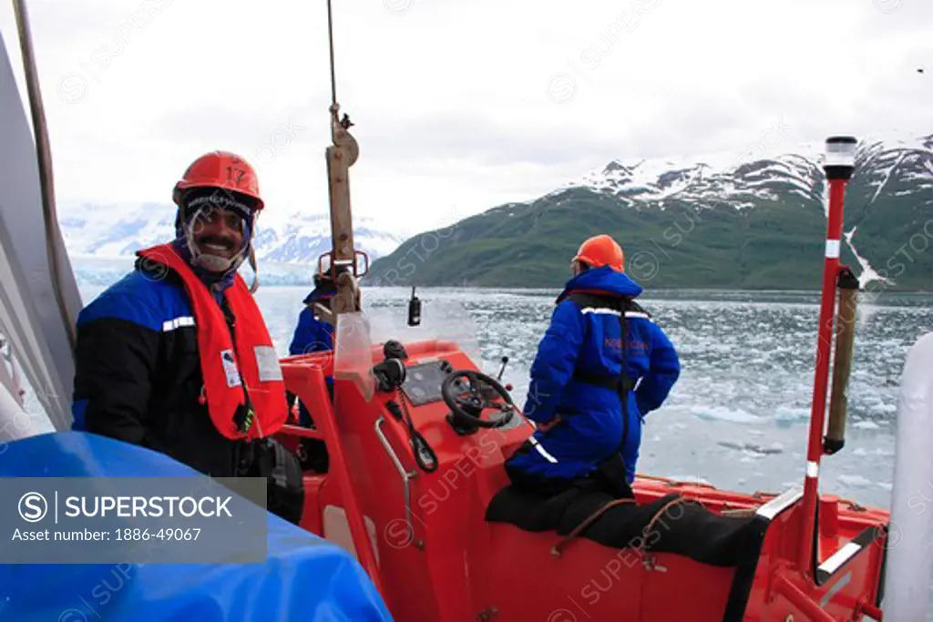 A man preparing for lowering lifeboat near Hubbard glacier ; the longest tidewater glacier in Alaska; Saint Elias  national park ; disenchantment bay ; Alaska ; U.S.A. United States of America