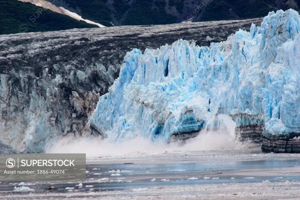 Calving ice falling off of Hubbard glacier ; the longest tidewater glacier in Alaska; Saint Elias  national park ; disenchantment bay ; Alaska ; U.S.A. United States of America