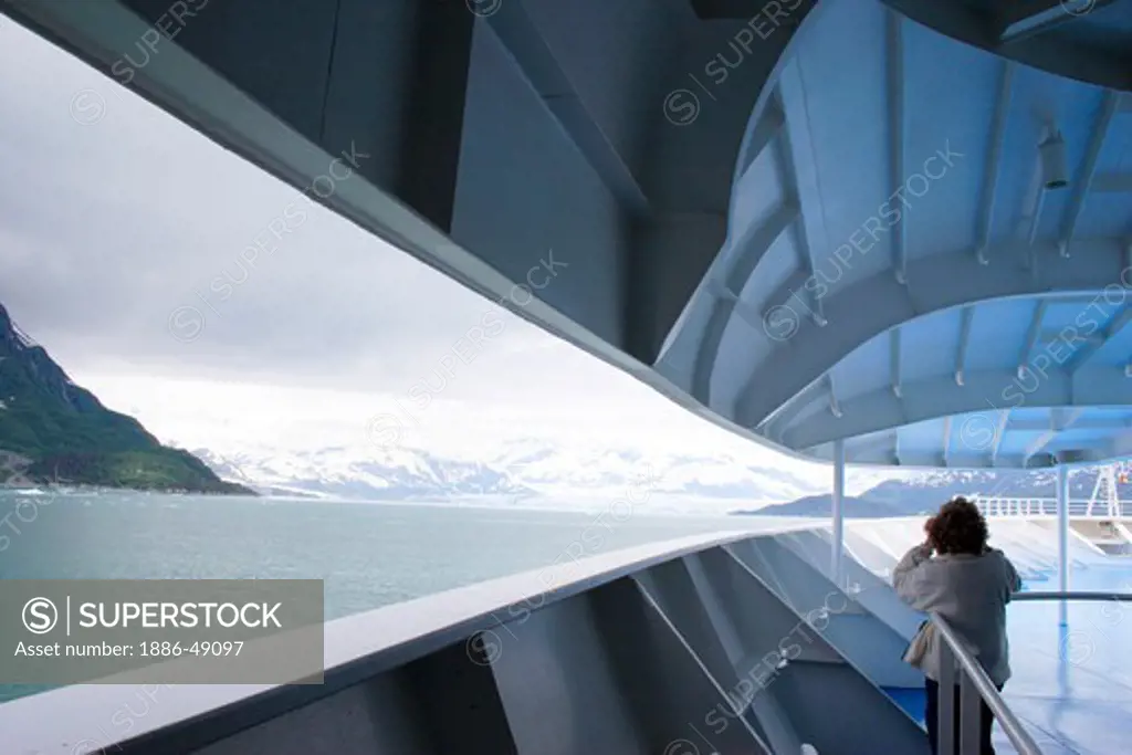 A lady watching from cruise ship a Hubbard glacier; The longest tidewater glacier in Alaska ; Saint Elias  national park ; Disenchantment bay ; Alaska ; U.S.A. United States of America