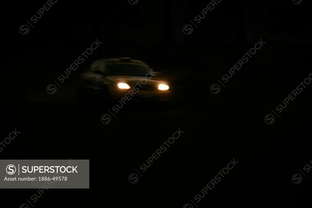 Yellow car with headlights on taking speedy turn in race held at Balewadi sports; complex ; Pune ; Maharashtra ; India NO MR/ PR on 5th may; 2006