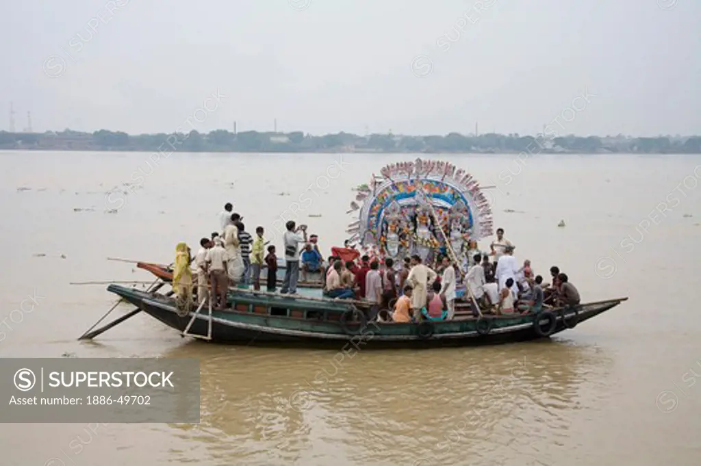 Farewell of the Durga Idol into the water of River Hooghly ; Visarjan ; Durga Pooja dussera Vijayadasami Navaratri Festival Celebration ; Calcutta Kolkata ; West Bengal ; India