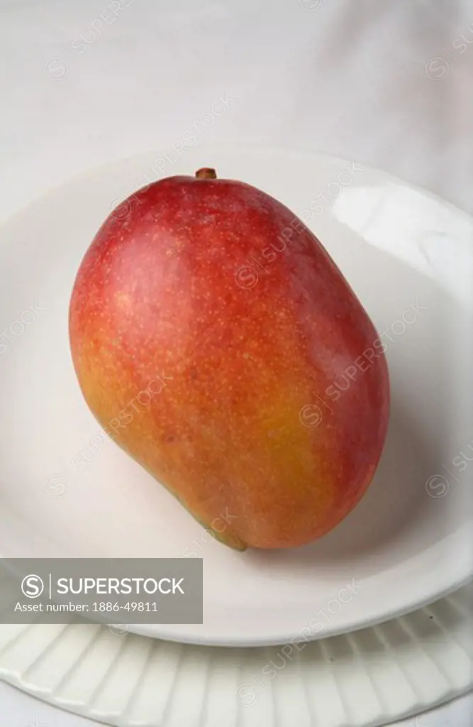Fruit ; Red Mango ; Sweet ; Sour test ; Colourful ; One mango in a plate ; India