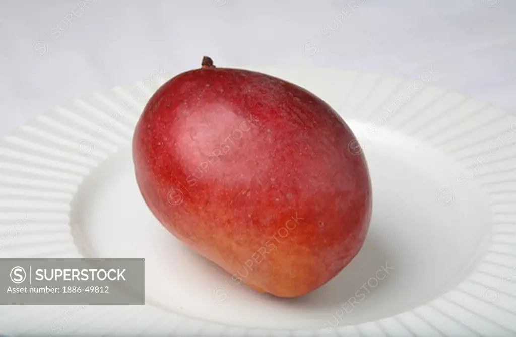 Fruit ; Red Mango ; Sweet ; Sour test ; Colourful ; One mango in a plate ; India