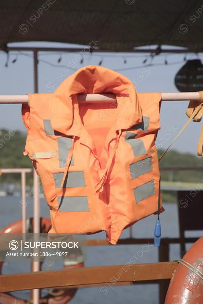 Orange colored life guard jacket and Rings on the Mandovi river cruise ; Panaji ; Goa ; India