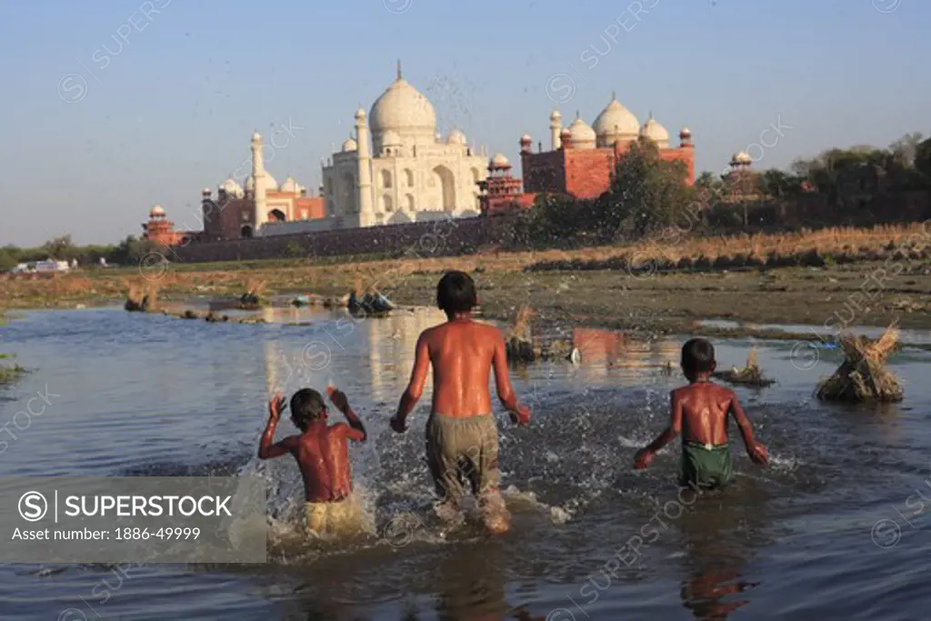 Children playing in Yamuna river at Taj Mahal Seventh Wonders of World ; Agra ; Uttar Pradesh ; India UNESCO World Heritage Site