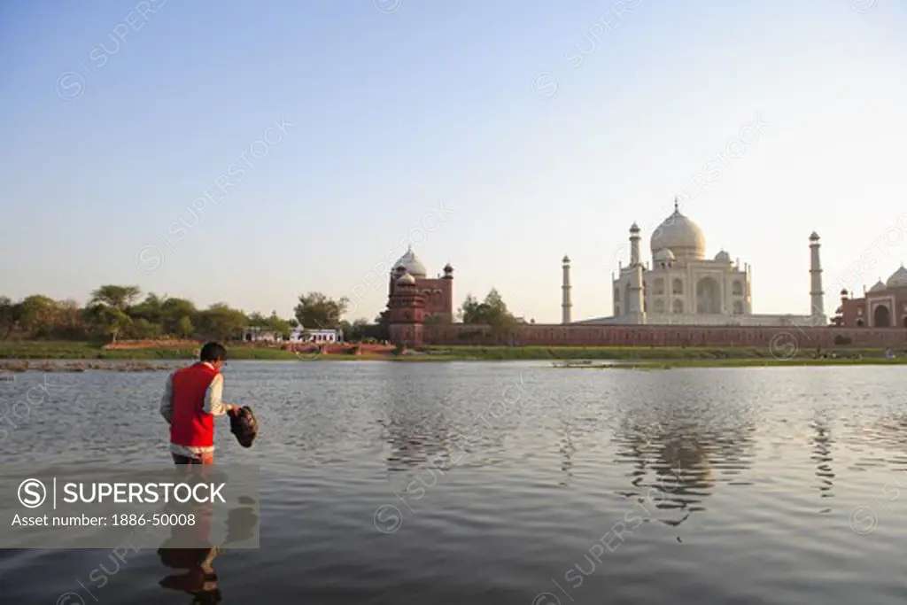 Man crossing river Yamuna at Taj Mahal Seventh Wonders of World ; Agra ; Uttar Pradesh ; India UNESCO World Heritage Site