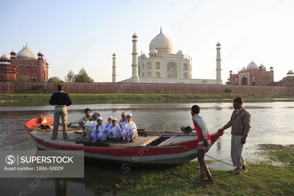 Villagers in boat in river Yamuna at Taj Mahal Seventh Wonders of World ; Agra ; Uttar Pradesh ; India UNESCO World Heritage Site