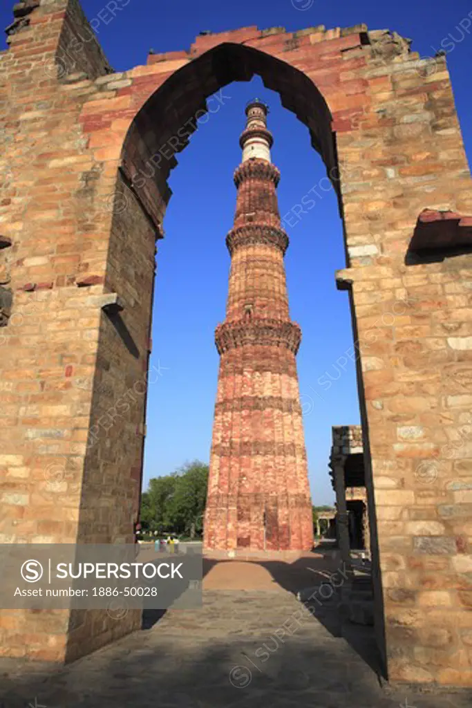Qutb Minar through arch built in 1311 red sandstone tower ; Indo-Muslim art ; Delhi sultanate ; Delhi; India UNESCO World Heritage Site