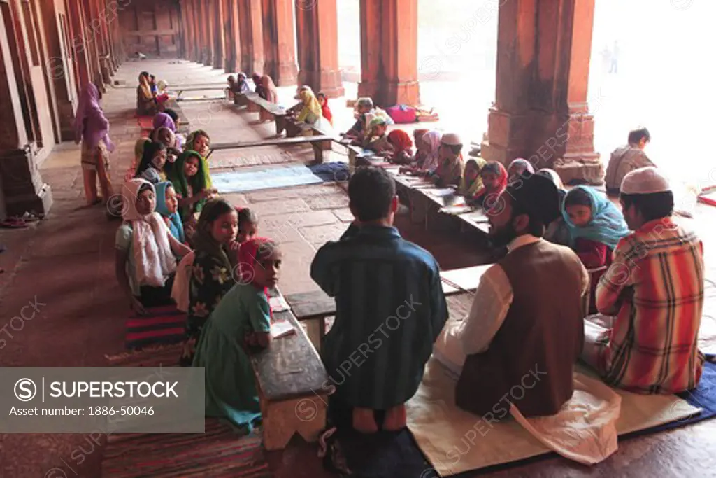 Students studying in Urdu Muslim School classroom Madarasa in Jami Masjid in Fatehpur Sikri built during second half of 16th century ; Agra; Uttar Pradesh ; India UNESCO World Heritage Site