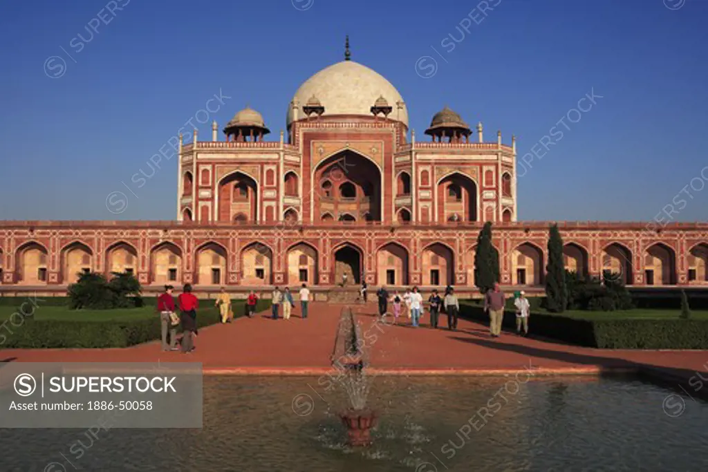 Tourists at Humayun's tomb built in 1570 made from red sandstone and white marble first garden-tomb on Indian subcontinent persian influence in mughal architecture ; Delhi; India UNESCO World Heritage Site