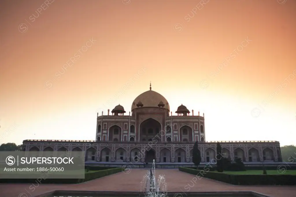 Sunrise at Humayun's tomb built in 1570 made from red sandstone and white marble first garden-tomb on the Indian subcontinent persian influence in mughal architecture ; Delhi ; India UNESCO World Heritage Site